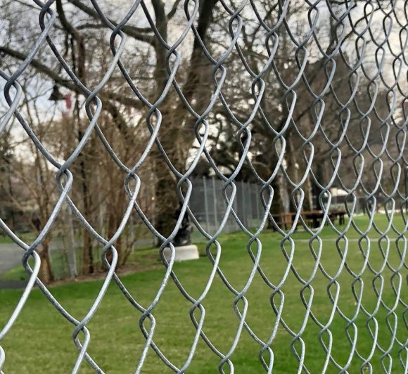 Ugly fencing on Promenade behind Octagon one step from coming down Metal fencing around DEP's emergency access road prevents access for picnics but may soon be coming down, according to RIOC.